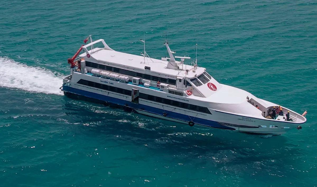 Green Ocean 2 — faster enclosed vessel with modern restaurant and glass panels Green Ocean 2 ferry front view at sea