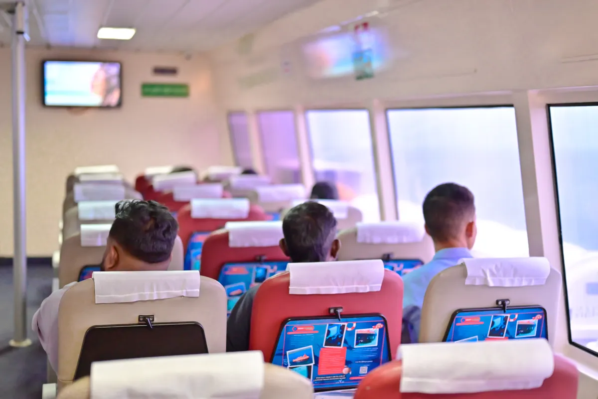 Private ferry interior — Makruzz Premium class with airline-style AC seating Makruzz ferry premium interior with AC cabin seating