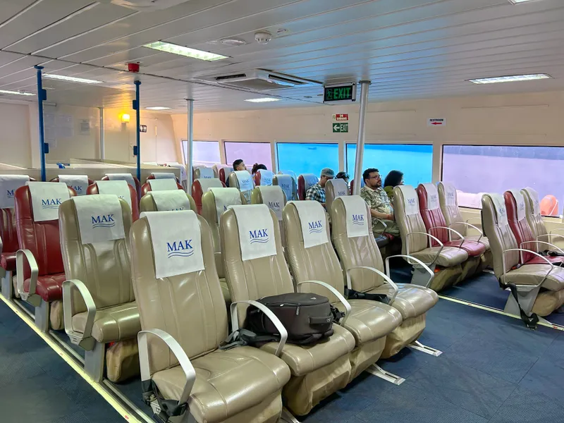 Deluxe seats offer more legroom and wider configuration than Premium Makruzz deluxe class seating showing wider seats and meal tray